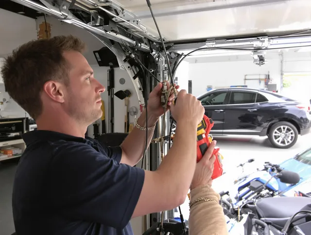 Longmont Garage Door Repair safety certified technician performing cable replacement in Longmont